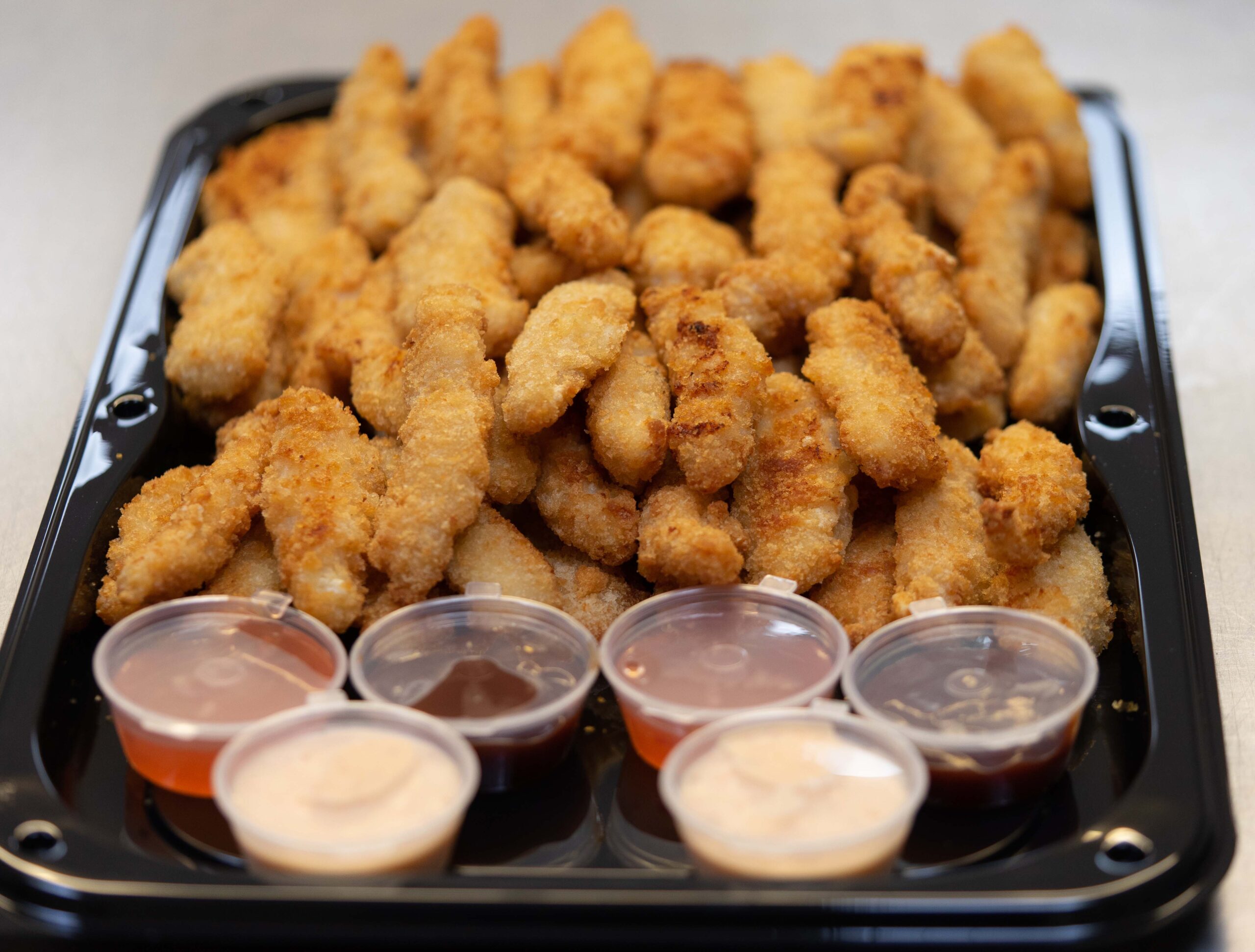 Portion of boneless chicken with dips