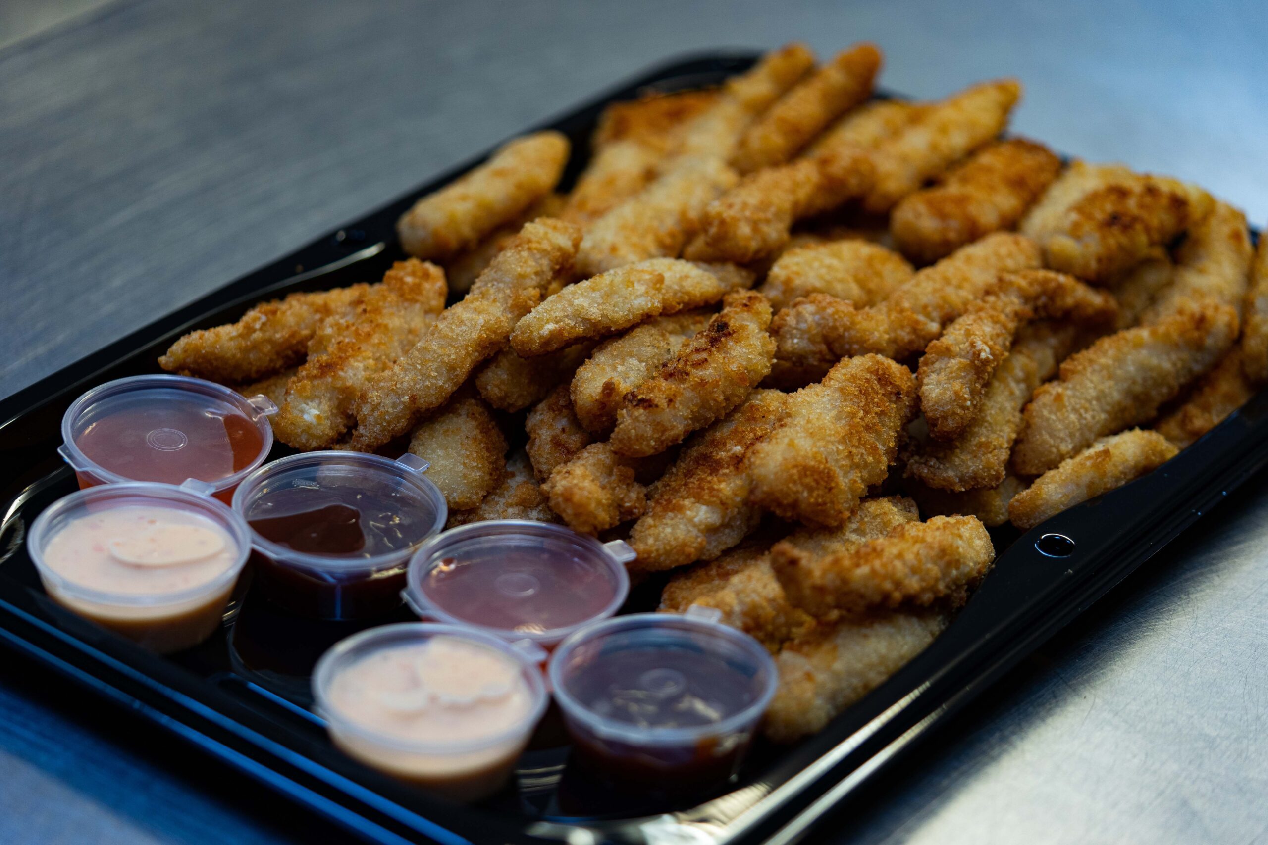 Portion of boneless chicken with dips
