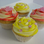 cupcakes of pink and yellow frosting with butterflies