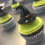 Cupcakes topped with green frosting and witches hat